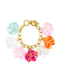 A gold-tone bracelet with multicolored iridescent petal charms attached to it, secured with a toggle closure.