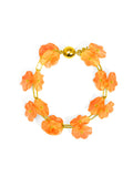A bracelet with an orange lotus flower design and a gold-colored clasp.
