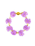 A bracelet with a purple lotus flower design and a gold-colored clasp.