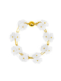 A bracelet with a white lotus flower design and a gold-colored clasp.