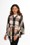 Woman wearing a checkered poncho on a white background