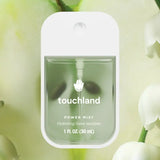 Touchland power mist hand sanitizer with green liquid on a light green background