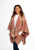 Woman wearing a pink plaid poncho on a white background