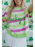 Person wearing a striped shirt with 'Lucky' and shamrock designs, standing in a festive setting.