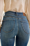 Blue jeans with a beige shirt worn by a person