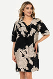 Woman wearing a black floral dress on a white background