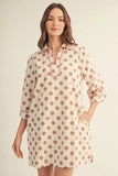 Woman wearing a polka dot dress on a beige background