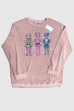 Pink sweatshirt with colorful nutcracker design on a light gray background