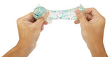 Hands holding an axolotl squishy  with colorful patterns on a white background