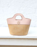 Pink and beige handbag with a brand logo on a white surface.