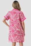 Woman wearing a pink floral dress on a white background
