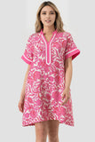 Woman wearing a pink floral dress on a white background