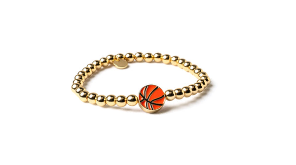 Gold bracelet with a basketball charm on a white background