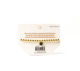 Product packaging with a gold necklace on a white background