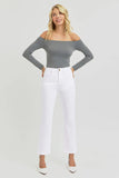 Woman wearing a gray off-shoulder top and white pants on a light gray background