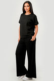 Woman wearing a black outfit on a white background