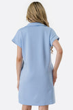Woman wearing a light blue dress against a white background