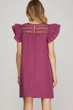 Purple dress with ruffled sleeves on a plain background