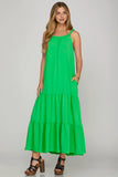 Woman wearing a green dress on a gray background