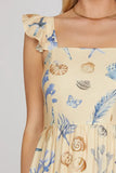 Beige dress with shell and butterfly pattern on a plain background