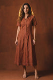 Woman wearing a brown dress against a matching background