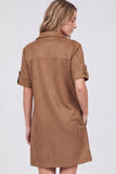 A woman shown from the back wearing a short-sleeve brown faux-suede shirt dress against a light gray studio background.
