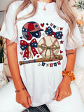 White t-shirt with patriotic baseball design worn by a person.