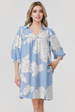 Woman wearing a blue floral dress on a white background