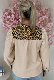 Person wearing a striped shirt with a leopard print collar against a pink floral background