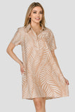Woman wearing a beige patterned dress on a white background