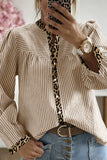 Person wearing a striped shirt with leopard print accents, taking a mirror selfie.