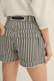 Black and white striped shorts worn by a person on a plain background