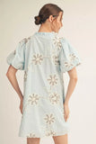 Light blue dress with floral embroidery on a plain background
