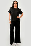 Woman wearing a black outfit on a white background