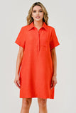 Woman wearing an orange dress against a plain background