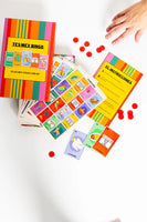 Colorful Tex-Mex Bingo game with cards and red markers on a white surface
