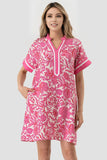 Woman wearing a pink floral dress on a white background