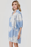 Woman wearing a blue floral dress on a white background