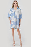 Woman wearing a blue floral dress on a white background