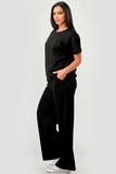 Woman wearing a black outfit on a white background