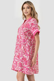 Woman wearing a pink floral dress on a white background