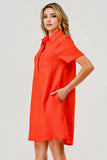Woman wearing a red dress against a plain background