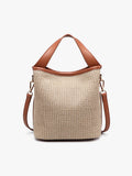 Beige woven handbag with brown leather handles and straps on a white background