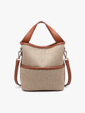 Beige woven handbag with brown leather straps on a white background
