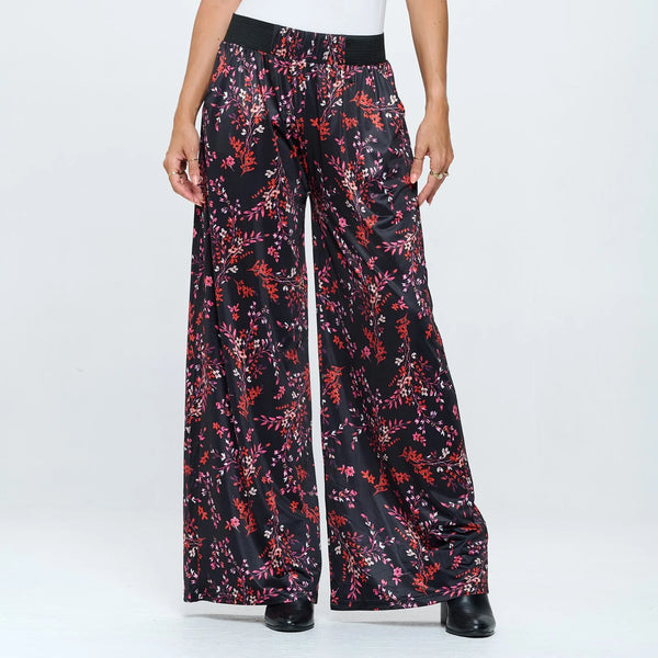 Floral-patterned pants worn by a person on a white background