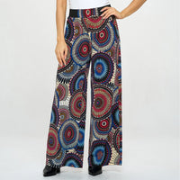 Colorful patterned pants worn by a person on a white background