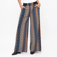 Patterned pants worn by a person on a white background