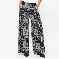 Black and white patterned pants worn by a person on a white background