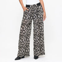 Leopard print pants worn by a person on a white background