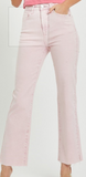 Light pink jeans worn by a person on a white background